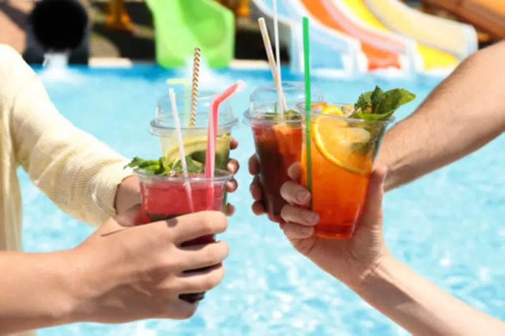 198084609 people with refreshing drinks in water park closeup
