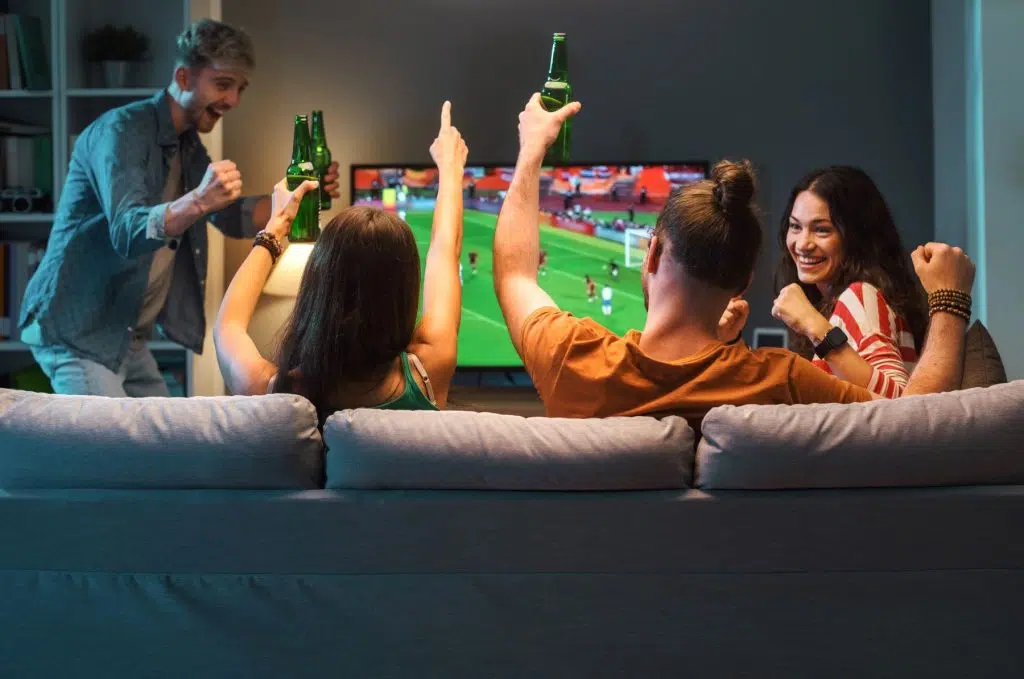 group of friends watching a football match on tv resized