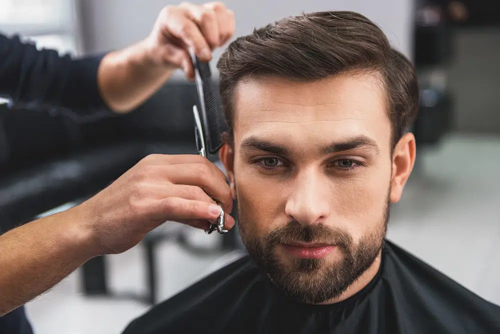 man getting haircut in salon